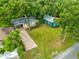 Aerial view of a charming home with mature trees and a brick driveway at 2208 Page Ave, Orlando, FL 32806