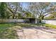Backyard with a shed, brick patio, and mature trees at 2208 Page Ave, Orlando, FL 32806