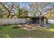 Backyard featuring a shed, fire pit, and mature trees at 2208 Page Ave, Orlando, FL 32806