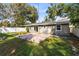 Spacious backyard with a brick patio and lush green grass at 2208 Page Ave, Orlando, FL 32806