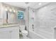 Bathroom with a bathtub shower, marble tiling, and granite countertops at 2208 Page Ave, Orlando, FL 32806
