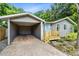 Charming single-story home featuring a carport, light-blue door, and newly built small wooden porch at 2208 Page Ave, Orlando, FL 32806
