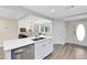 Well-lit kitchen with a center island and stainless steel appliances open to the living area at 2208 Page Ave, Orlando, FL 32806