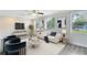 Bright living room with modern decor, large windows, and stylish furniture arrangement at 2208 Page Ave, Orlando, FL 32806
