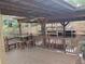 Exterior shot of a covered wooden dock with a dining set overlooking the water at 2215 Hontoon Rd., Deland, FL 32720