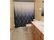 Bathroom featuring a shower with a patterned curtain, a vanity with drawers, and tile flooring at 2215 Hontoon Rd., Deland, FL 32720