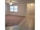 Living room area with tile and carpet flooring and a large window at 2215 Hontoon Rd., Deland, FL 32720