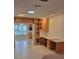 Office with built in shelving and a view into kitchen area at 2215 Hontoon Rd., Deland, FL 32720