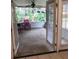 Screened in patio with chairs and lots of lush landscaping in the background at 2215 Hontoon Rd., Deland, FL 32720