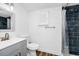 Bathroom boasts a modern vanity, toilet, and a shower with striking blue tile at 226 3Rd St, Orlando, FL 32824