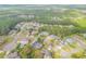 An aerial view showcases homes with pools and green landscaping in a quiet neighborhood surrounded by trees at 27 Foxhunter Flt, Ormond Beach, FL 32174