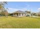 Well-maintained backyard featuring a large lawn, mature trees and a fenced perimeter at 27 Foxhunter Flt, Ormond Beach, FL 32174
