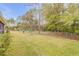 Expansive backyard with mature trees, manicured lawn and a secure perimeter fence at 27 Foxhunter Flt, Ormond Beach, FL 32174