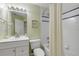 Traditional bathroom with white fixtures, shower-tub, tile floor and updated lighting at 27 Foxhunter Flt, Ormond Beach, FL 32174
