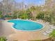 A large community pool surrounded by lounge chairs and lush greenery, perfect for relaxation and social gatherings at 27 Foxhunter Flt, Ormond Beach, FL 32174
