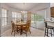 Cozy dining area featuring a wooden table, chandelier, and sliding glass doors to a screened patio at 27 Foxhunter Flt, Ormond Beach, FL 32174