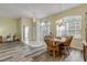Open dining area with views of front door, wood floors and chandelier at 27 Foxhunter Flt, Ormond Beach, FL 32174