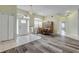 Bright dining room with wood floors, a chandelier, and an archway framing the entrance at 27 Foxhunter Flt, Ormond Beach, FL 32174