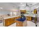 Spacious kitchen with wooden cabinetry, island and breakfast bar at 27 Foxhunter Flt, Ormond Beach, FL 32174