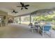 Inviting screened lanai with umbrella-covered table set and ceiling fans at 27 Foxhunter Flt, Ormond Beach, FL 32174