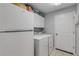 Convenient laundry room with a washer, dryer, and a refrigerator for drinks and other items at 27 Foxhunter Flt, Ormond Beach, FL 32174