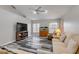 Bright living room features attractive flooring, large windows, and a vaulted ceiling with ceiling fan at 27 Foxhunter Flt, Ormond Beach, FL 32174
