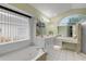 Bright main bathroom features dual sinks, a vanity area, a garden tub, and a walk-in shower at 27 Foxhunter Flt, Ormond Beach, FL 32174