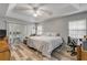 Bright main bedroom features a tray ceiling, ceiling fan, a sitting area and access to an outdoor patio at 27 Foxhunter Flt, Ormond Beach, FL 32174