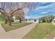 Charming single-story home featuring a well-manicured front lawn and a long driveway leading to the entrance at 2814 Bonneville Dr, Orlando, FL 32826