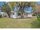 Well-maintained exterior with mature trees, showcasing the home's curb appeal and landscaping at 2814 Bonneville Dr, Orlando, FL 32826