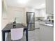 Bright eat-in kitchen featuring white cabinets, stainless steel refrigerator, and granite countertops at 2814 Bonneville Dr, Orlando, FL 32826
