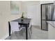 Eat-in kitchen with granite countertops, stainless steel refrigerator, and a modern dining set at 2814 Bonneville Dr, Orlando, FL 32826