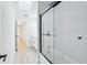 Bathroom featuring a walk-in shower with white subway tile, wood-look flooring, and natural light at 305 Haverlake Cir, Apopka, FL 32712
