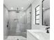 Modern bathroom featuring a glass-enclosed shower with gray tiling and a sleek, stylish vanity at 305 Haverlake Cir, Apopka, FL 32712