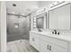 Modern bathroom with double vanity, granite countertops, and glass-enclosed shower at 305 Haverlake Cir, Apopka, FL 32712