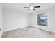 Charming bedroom with wood-look floors, a ceiling fan, and a bright window overlooking a green yard at 305 Haverlake Cir, Apopka, FL 32712