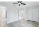 Spacious bedroom features wood-look flooring, ample closet space, and a ceiling fan at 305 Haverlake Cir, Apopka, FL 32712