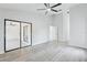 Large bedroom with sliding glass doors, ceiling fan, and light gray flooring at 305 Haverlake Cir, Apopka, FL 32712
