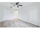 Bright and spacious bedroom boasts a ceiling fan, wood-look flooring, and ample closet space at 305 Haverlake Cir, Apopka, FL 32712