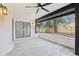 Inviting covered patio with neutral tile flooring and a view to the backyard at 305 Haverlake Cir, Apopka, FL 32712