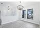 Bright dining room with wood floors, chandelier, and large windows at 305 Haverlake Cir, Apopka, FL 32712