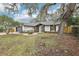 Lovely home with a manicured front yard, a two-car garage, and mature trees draped in Spanish moss at 305 Haverlake Cir, Apopka, FL 32712