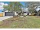 Charming home with a well-manicured lawn, large tree, and a two-car garage in a quiet neighborhood at 305 Haverlake Cir, Apopka, FL 32712