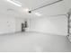 Spacious garage with epoxy flooring, ample lighting, and storage space at 305 Haverlake Cir, Apopka, FL 32712