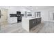 Modern kitchen with stainless steel appliances, island, and sleek cabinetry at 305 Haverlake Cir, Apopka, FL 32712
