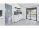 Kitchen with white cabinets, open shelves, and glass sliding door to outdoor space at 305 Haverlake Cir, Apopka, FL 32712