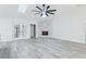 Living room featuring brick fireplace, skylights, and French doors to backyard at 305 Haverlake Cir, Apopka, FL 32712