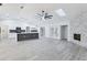 Spacious living area with fireplace, skylight, and island kitchen at 305 Haverlake Cir, Apopka, FL 32712