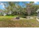 Backyard view of pond surrounded by stone and grassy lawn at 3450 Whitner Way, Sanford, FL 32773