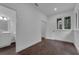 Bright bedroom featuring wood-look tile floors, a window, and a partially-visible bathroom at 3450 Whitner Way, Sanford, FL 32773